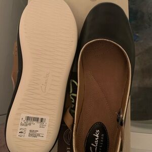 Clarks Black and Tan Flats with Suede-like Finish